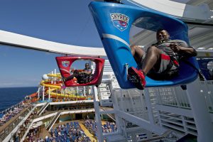 Guests onboard Carnival Vista participate in SkyRide, an opportunity to pedal hanging recumbent-like bikes around an 800-foot-long suspended track some 150 feet above the sea. The largest and most innovative cruise vessel in Carnival Cruise Line's fleet, Carnival Vista measures 133,500 tons, 1,055 feet long and has a guest capacity of almost 4,000 passengers. Photo by Andy Newman/Carnival Cruise Line